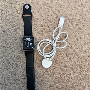 Apple Watch Series 3.  Black Smartwatch with White Charger